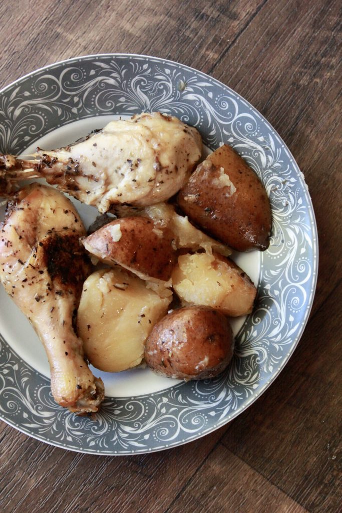 Chicken drumsticks and potaoes, close up picture