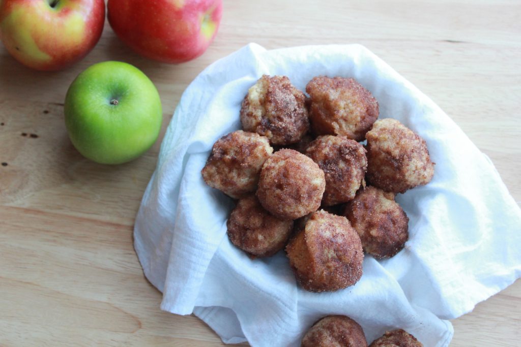 mini apple donut-muffins in a bowl with apples on the side