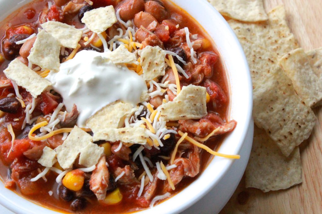 Photo of taco soup served with tortilla chips on the side