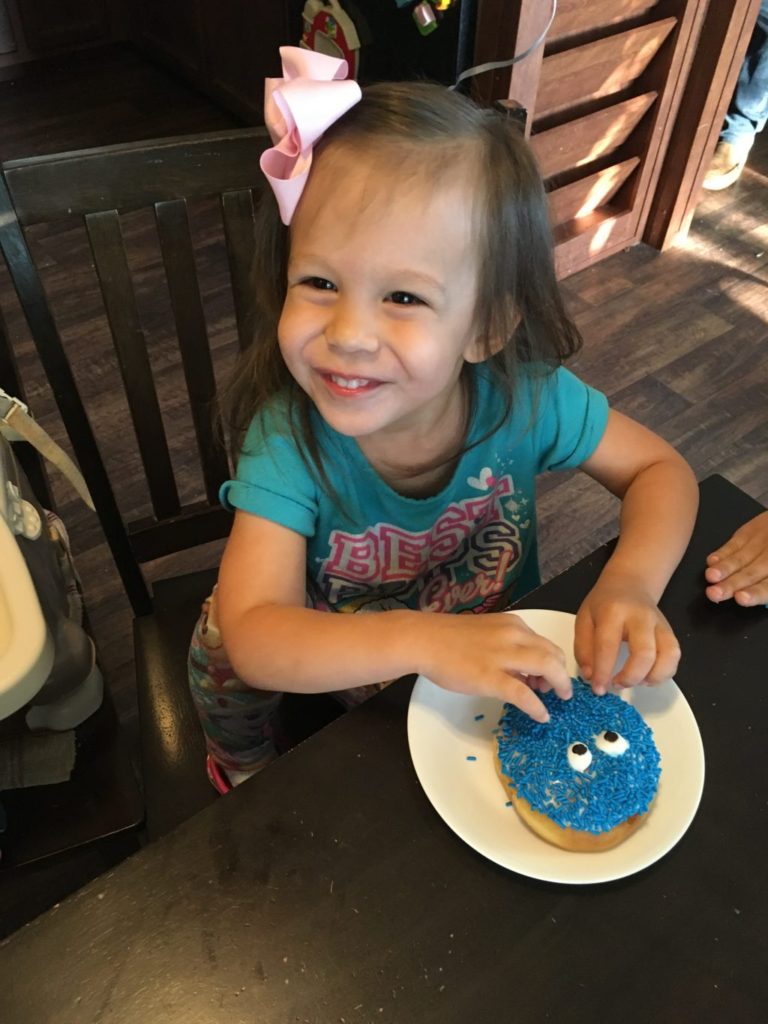 Girl with birthday donut