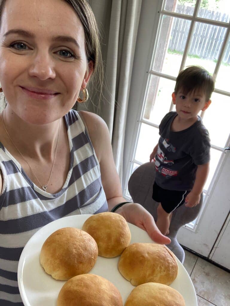 me holding a plate of chicken and cheese stuffed biscuits