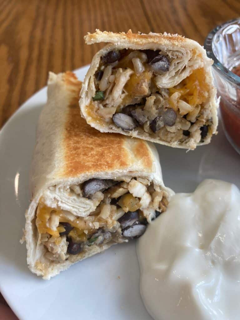 Crispy Chicken, Rice and Bean Burritos on a white plate.