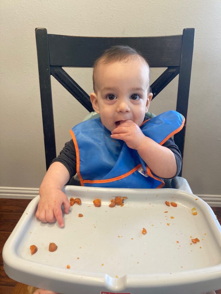 9 month old eating in high chair