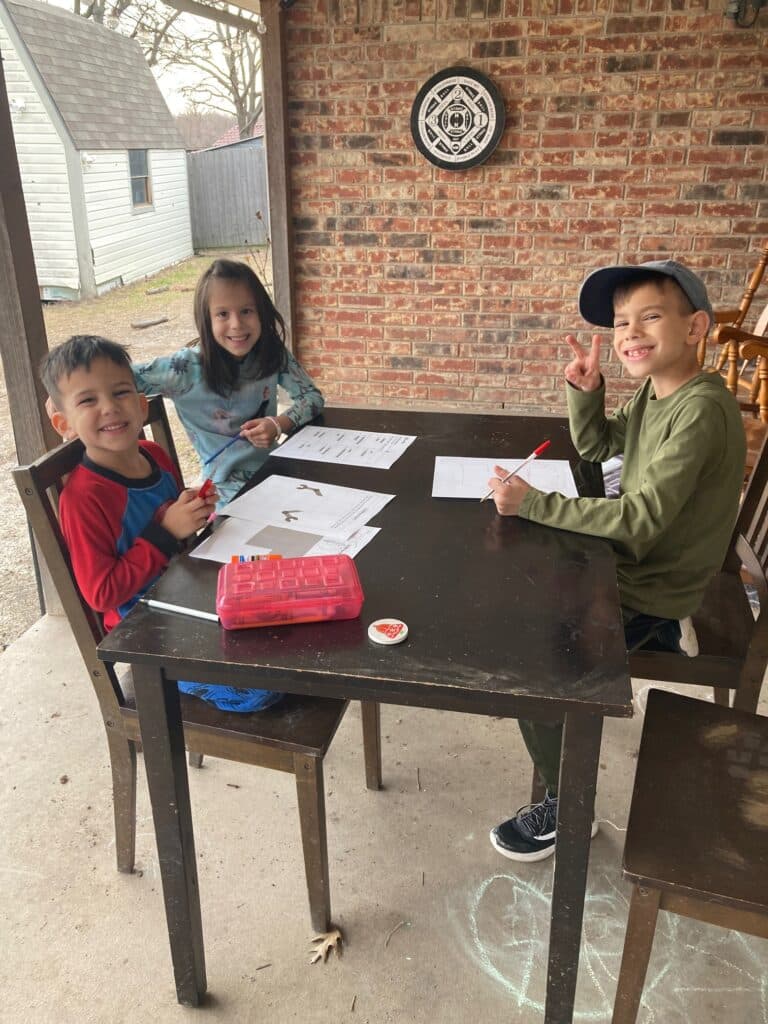 Kids at the table working on their homeschool work