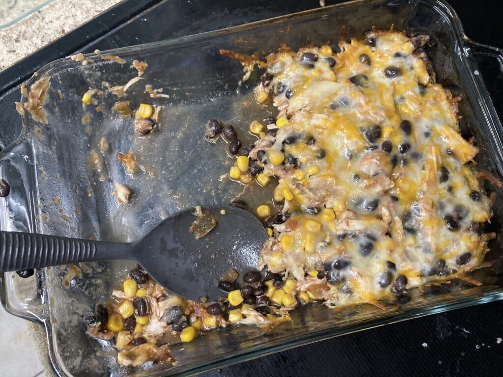 glass baking dish with Mexican shredded chicken casserole with black beans